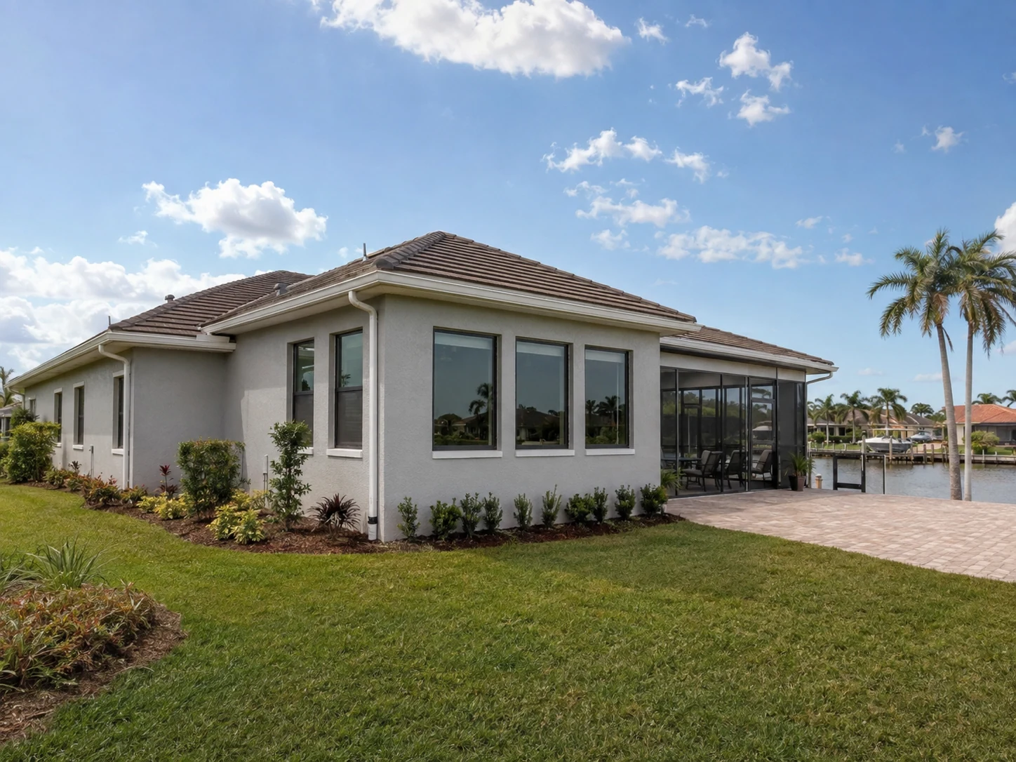 Custom Southwest Florida canal-front home addition with screened outdoor living