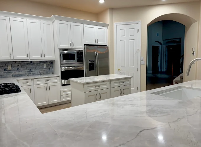ZenTek high-end custom kitchen with white cabinetry and coordinated stone countertops