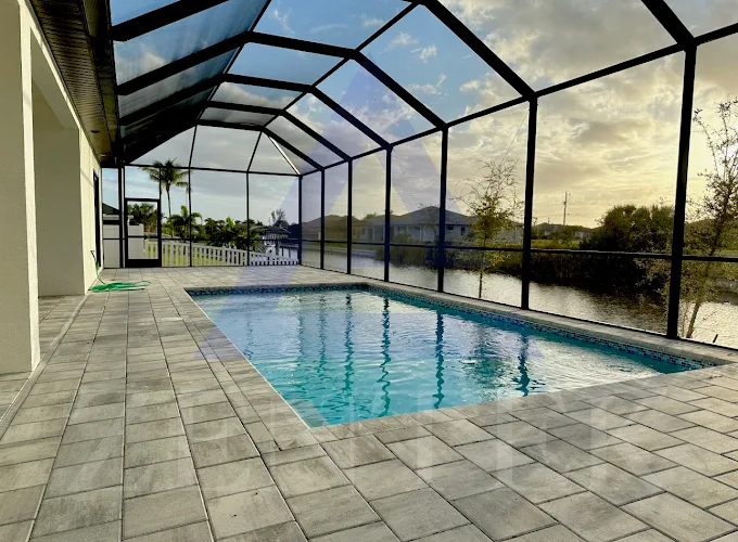 The Stelten screened lanai and pool overlooking a Southwest Florida canal